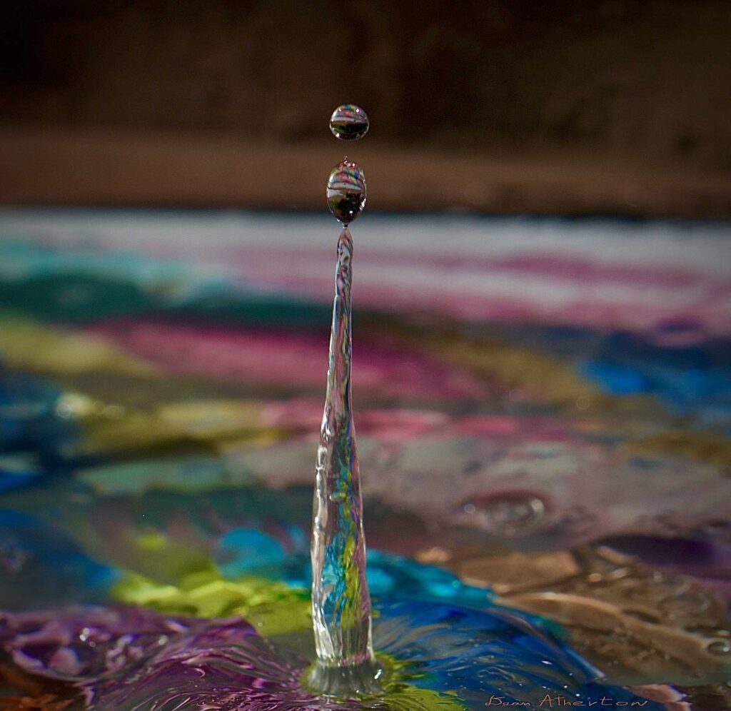 Water drop photography ,producing a double ware drop with reflection inside the water drop.